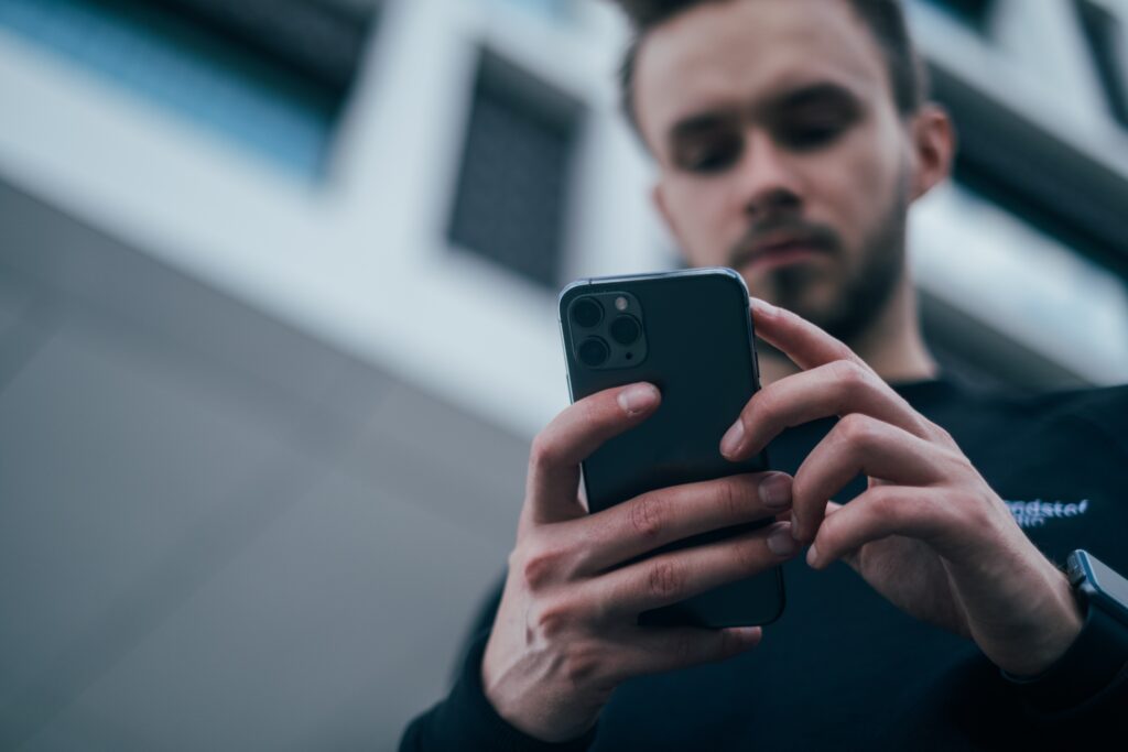 Man typing on iPhone
