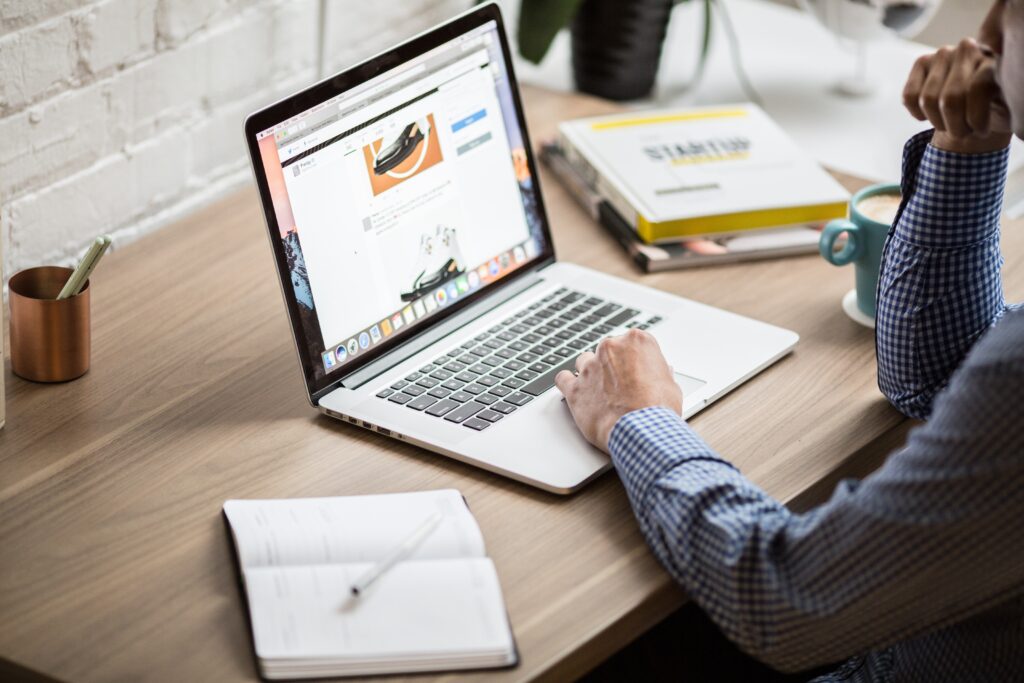 Small Business website on a laptop with note pad