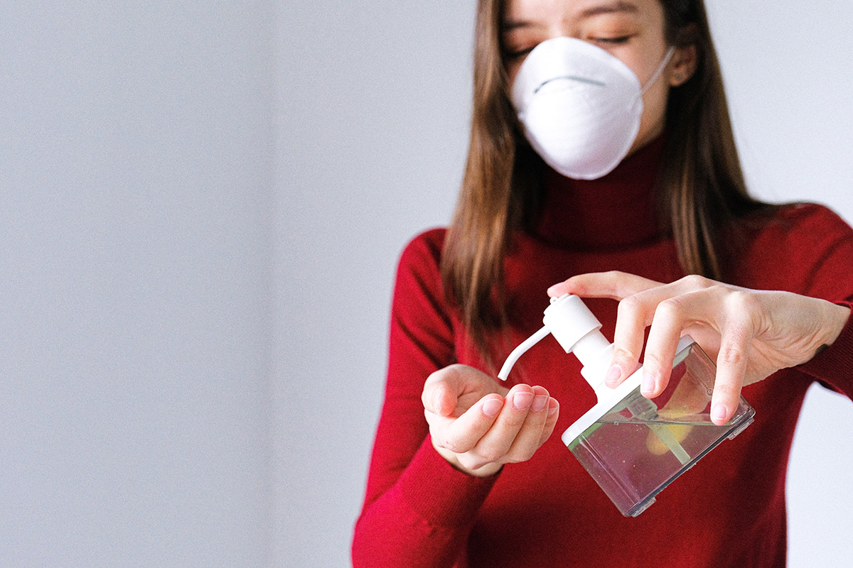 Woman Putting On Hand Sanitizer
